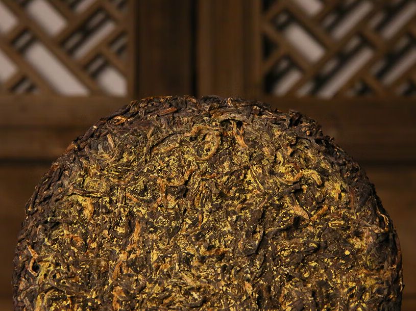 The round Fu brick tea cake is densely covered with golden fungus flowers.jpg